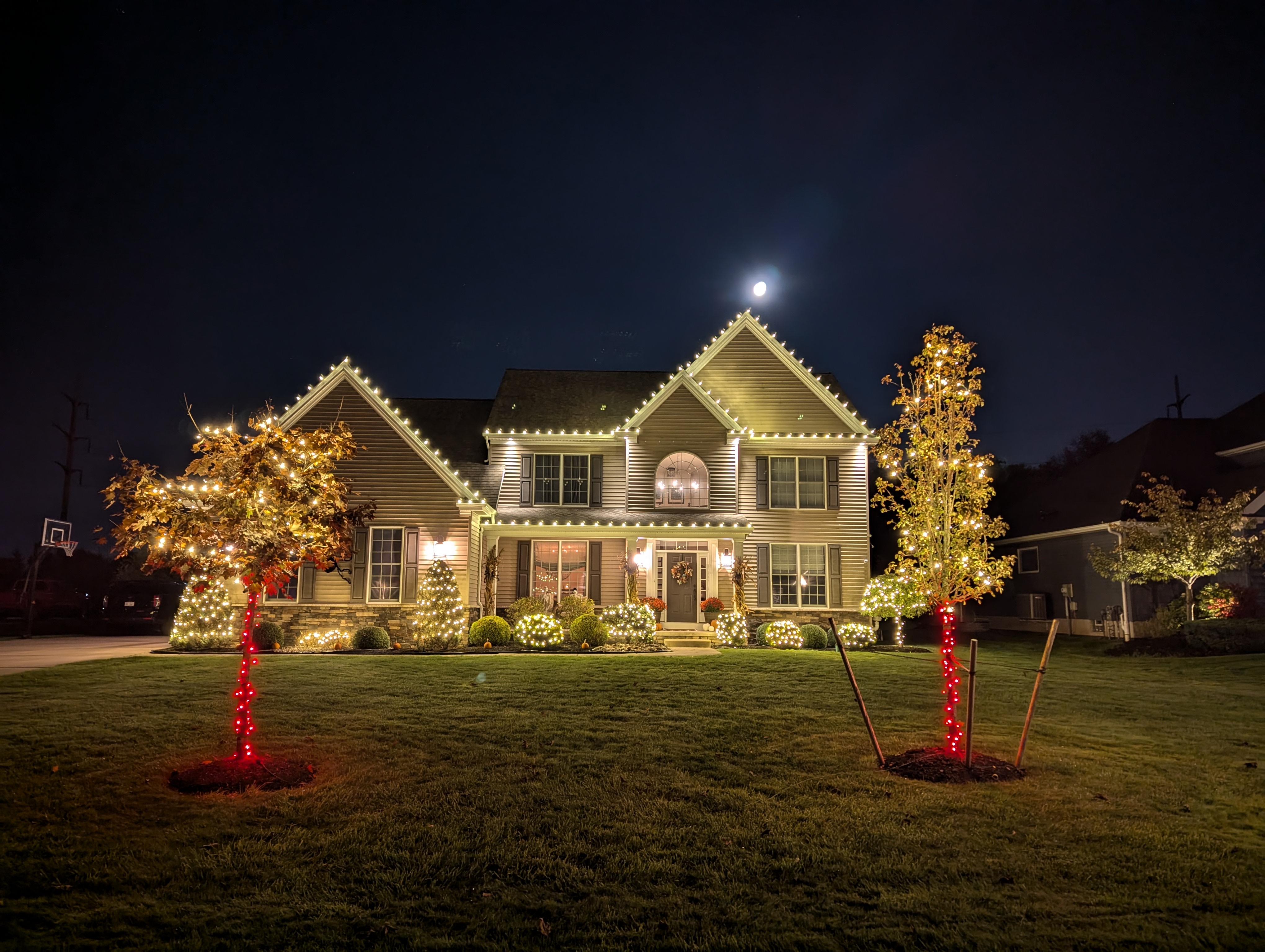 Professional warm-white Christmas-light installation on a Western New York home